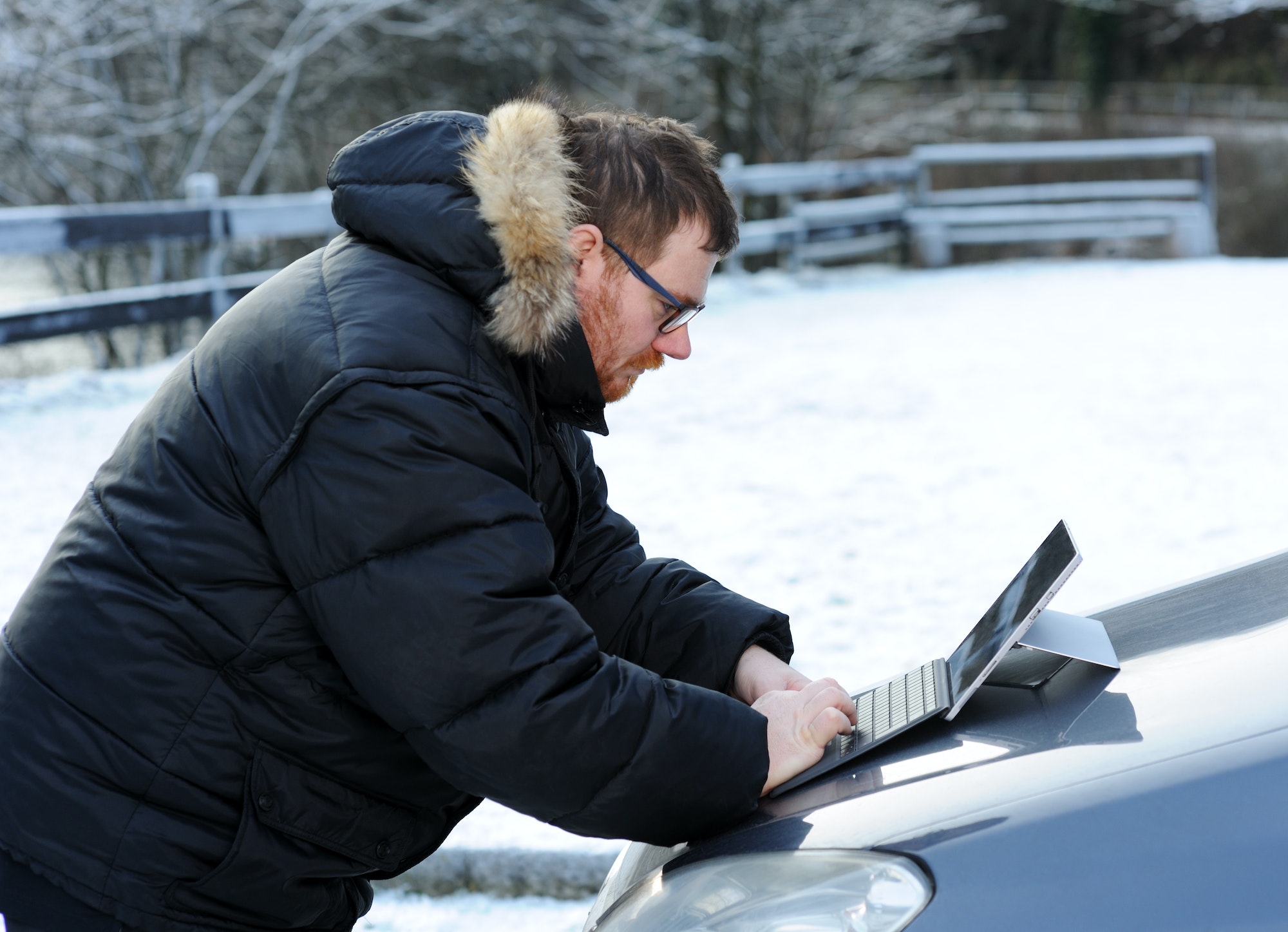 man using tablet on the car